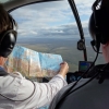 Instructor looking at chart in R44 cockpit
