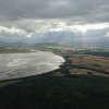 Scottish firth with clouds and sun