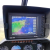 GPS in R44 cockpit showing Wick Airport