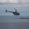 R44 in flight over sea