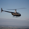 R44 silhouette against blue sky